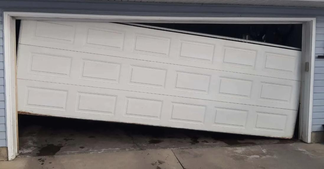 Garage door off track and leaning, in need of repair