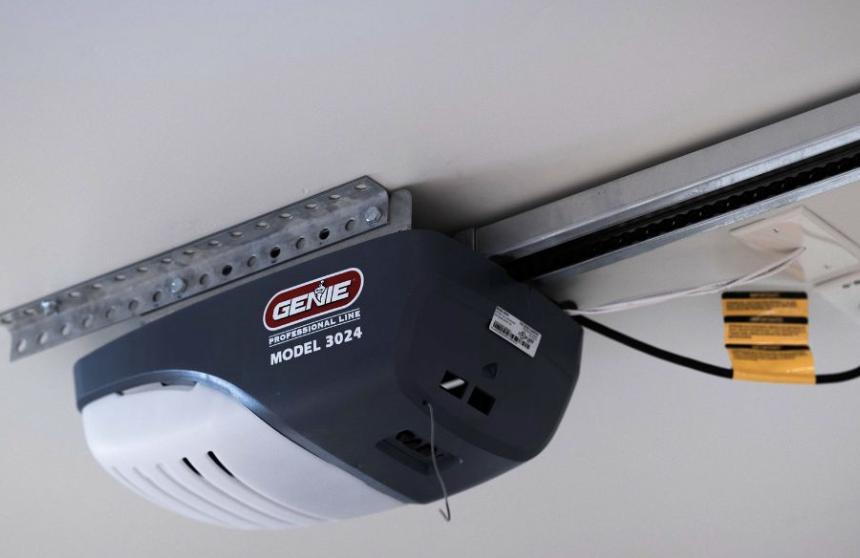 Genie garage door opener installed on a steel track