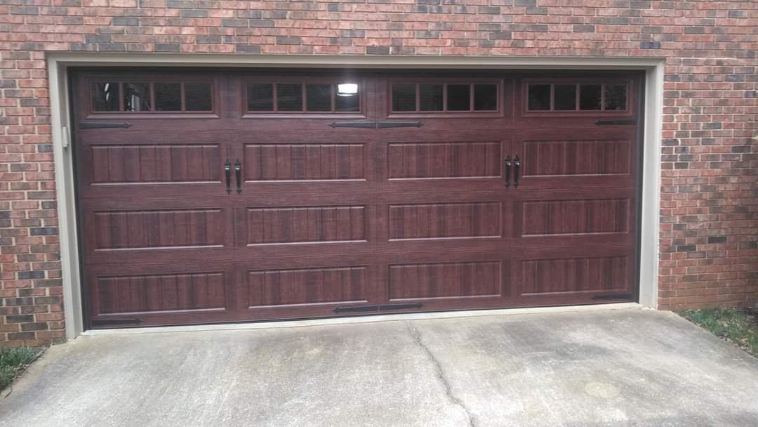 Walnut carriage-house garage door on a brick home