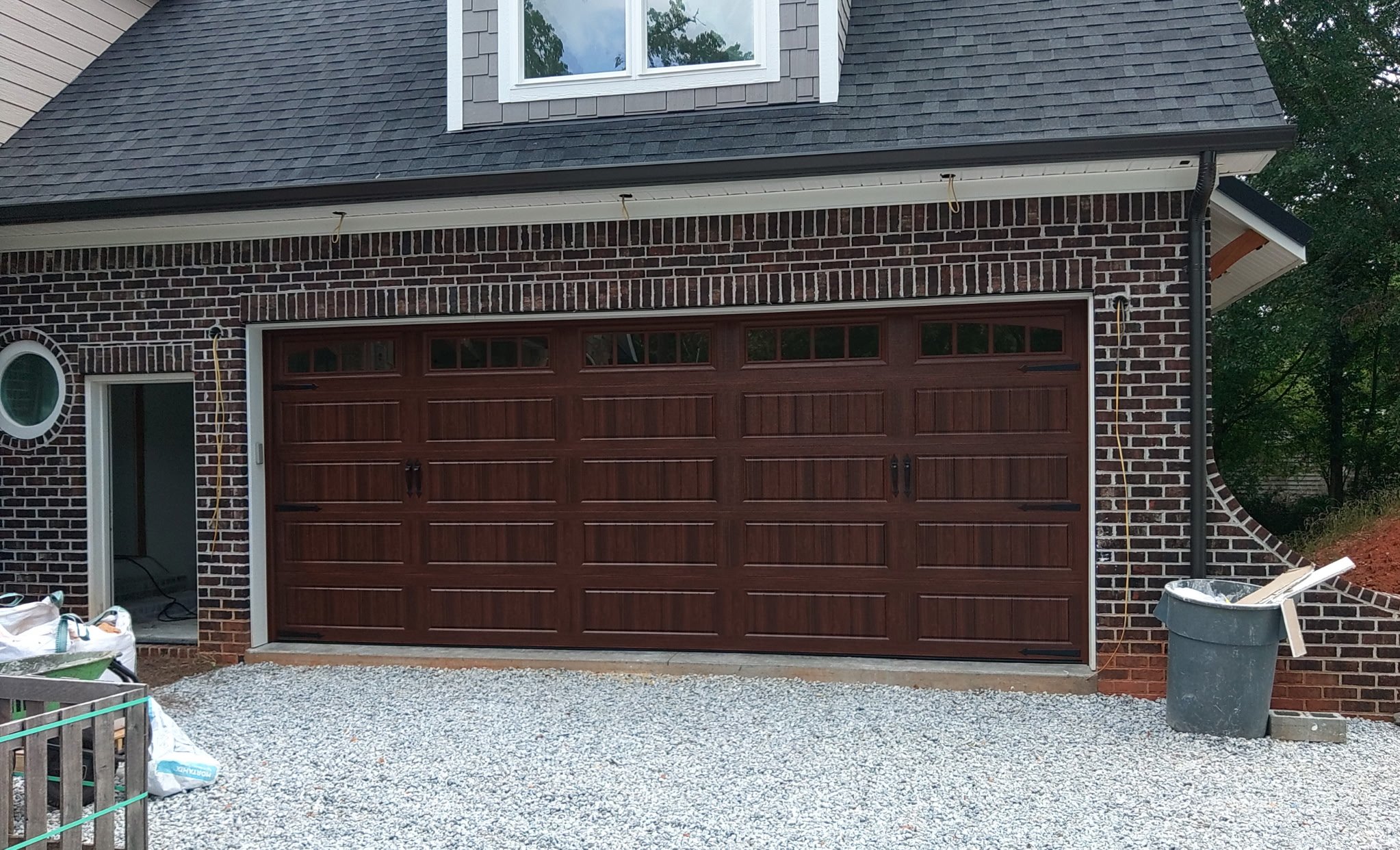 New wood-look garage door installed on a home under construction